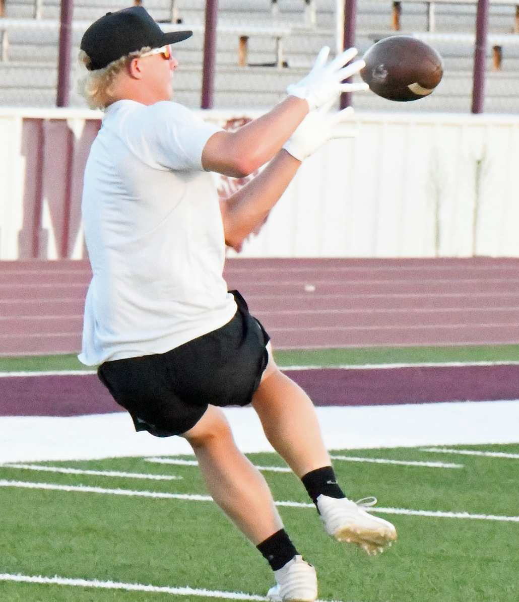 Bradyn Redman catches an out route, during route running drills at Littlefield’s Park Practice on Monday at Wildcat Stadium. (Staff Photo by Derek Lopez)