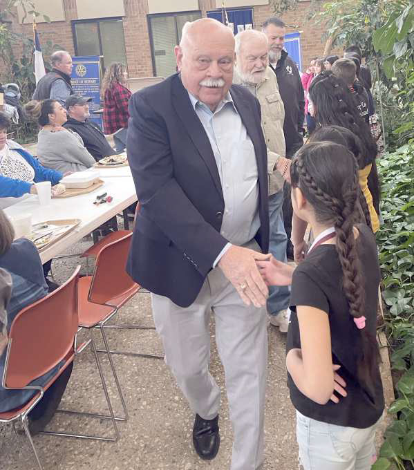 Rotary members shake hands with the Rotary Readers, Writers and Reasoners, congratulating them on their accomplishments. (Submitted Photo)