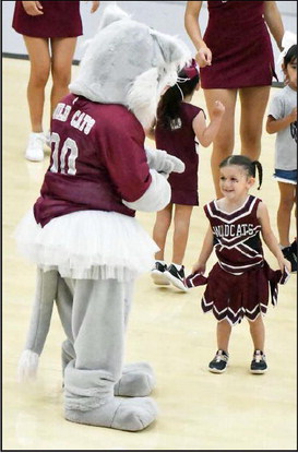 Hazel Jaramillo dances with the Wildcat mascot during the second day of cheer camp n June18th at Wildcat Gymnasium. (Staff Photo by Derek Lopez)