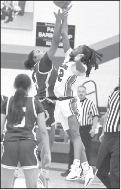 Littlefield’s Nia Cleveland (11), goes up for the opening tip- off to get the Lady Cat’s season underway last weekend at Estacado. (Staff Photo by Derek Lopez)