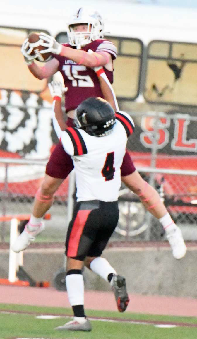 Littlefield senior receiver, Bradyn Redman (15), makes a huge catch over a Slaton defensive back to set the Wildcats up with first and goal, during the first half of the Wildcats, 55-36, victory over Slaton on Friday to open district play. (Staff Photo by Derek Lopez)