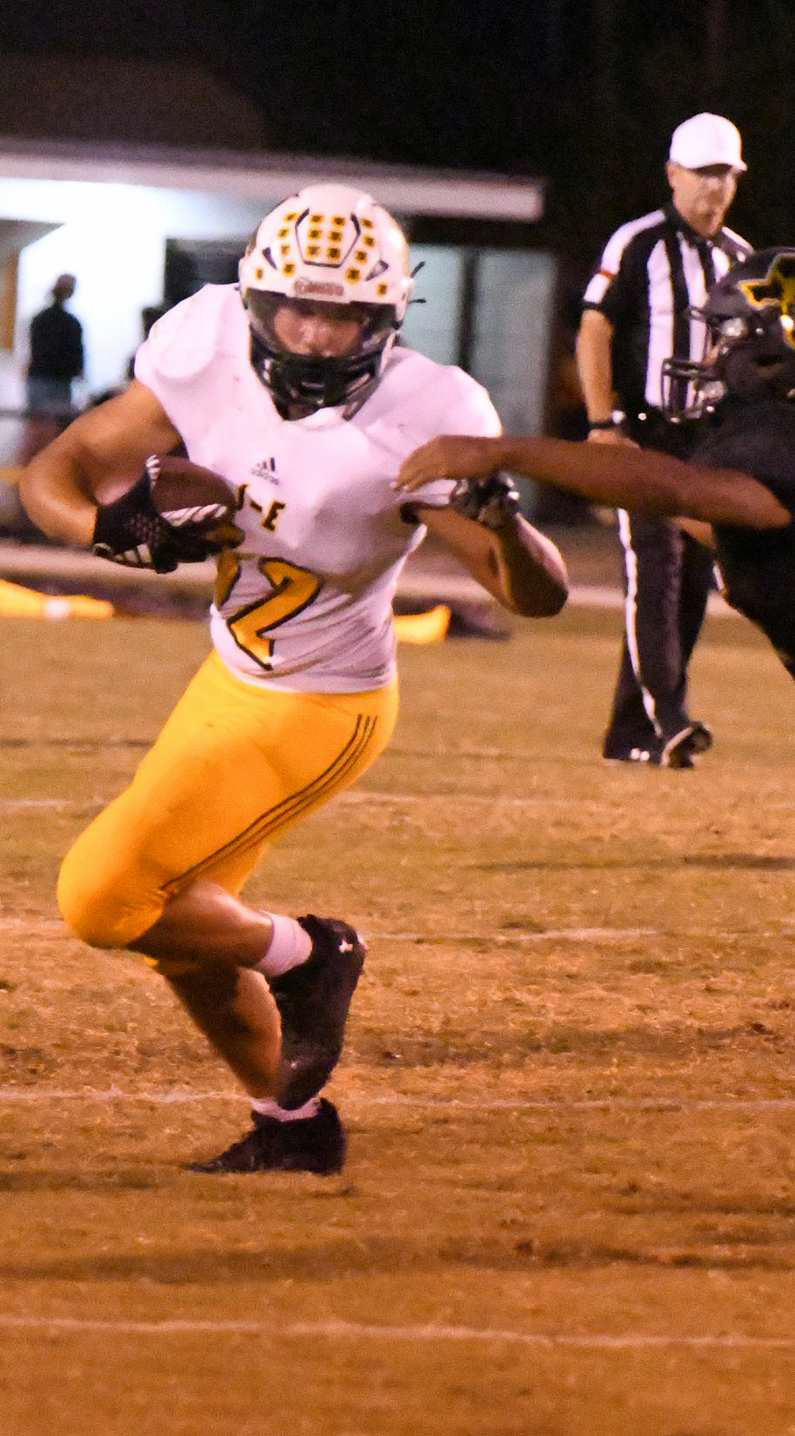 Springlake-Earth’s Tyler Tanaro catches a short pass from Froylan Agundiz, as he cuts it up field for a solid gain, during the Wolverine’s, 60-34, loss at Happy on Thursday night. (Staff Photo by Derek Lopez)