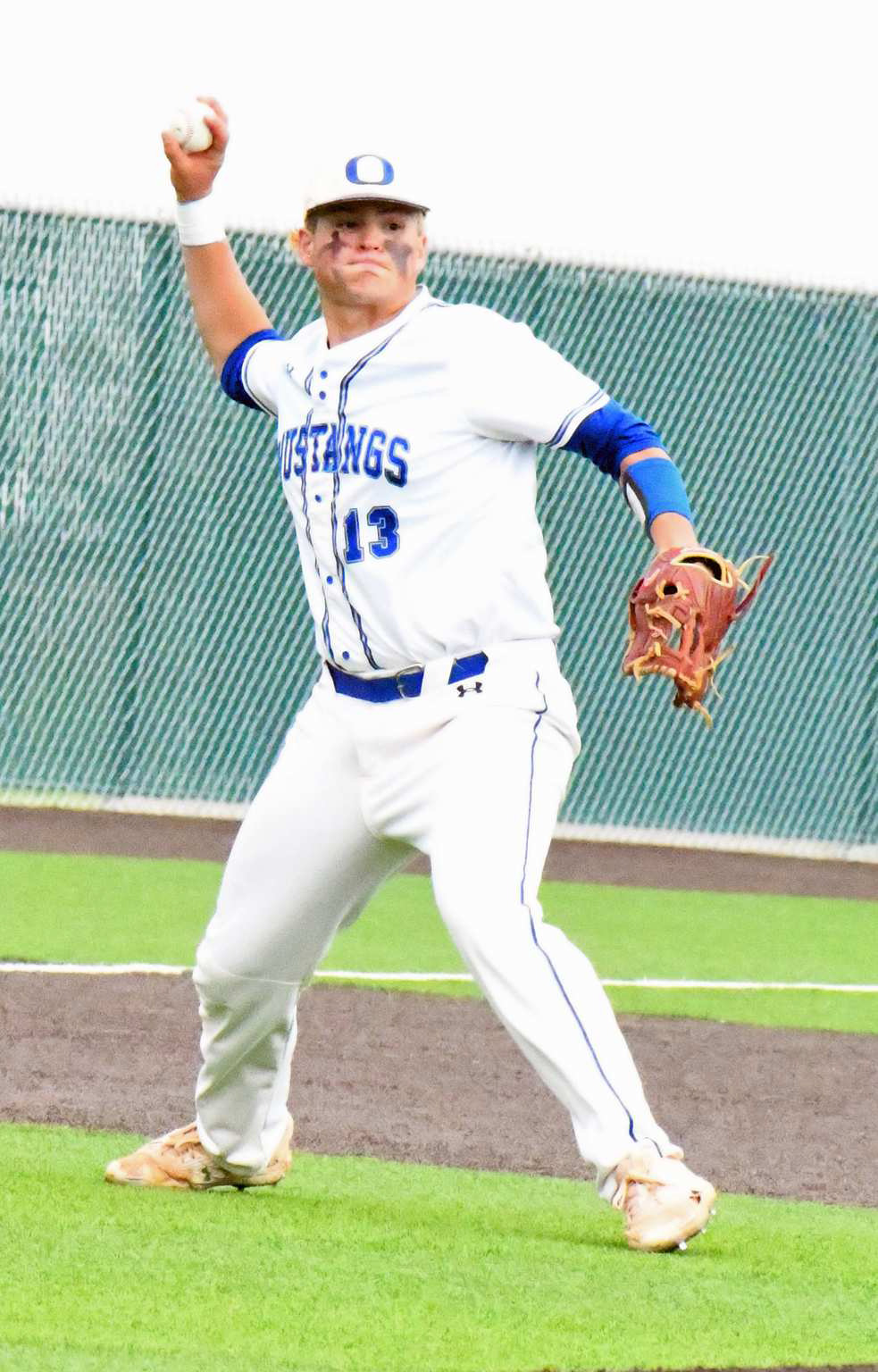 OUT AT FIRST - Olton senior third baseman, Paul Lopez, fields up a grounder at third base and fires it across the diamond for an out, during the Mustangs’, 15-5, game 2 Regional Quarterfinal loss to New Home on Thursday evening in Littlefield. (Staff Photo by Derek Lopez)