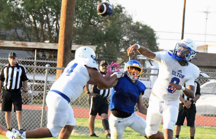 Olton quarterback Raymond Ramirez fires a dart to his left looking for a receiver in the endzone on the goal line, during the Mustangs’ scrimmage with the Owls on Thursday at Owl Stadium. (Staff Photo by Derek Lopez)