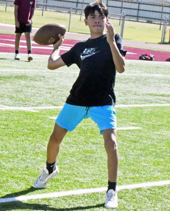 Campers at the 2025 Littlefield Youth Football Camp play a game of speedball before transitioning to offensive drills, during the second day of camp on Tuesday. (Staff Photo by Derek Lopez)