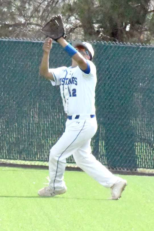 GETTING UNDER THE BALL - Olton junior right fielder, Jacob Marquez, catches a fly ball in right field for an out, during game one of the Mustangs Regional Quarterfinal loss to New Home on Thursday in Littlefield. (Staff Photo by Derek Lopez)