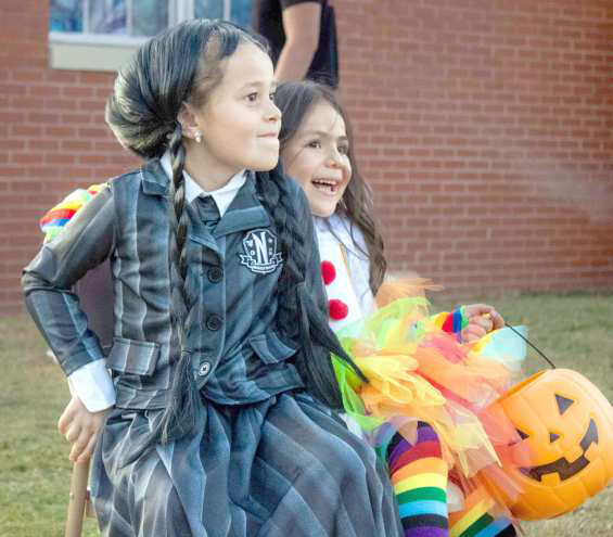Wednesday Adams and a clown compete for the final chair in a round of musical chairs at the Crescent Park Church of Christ’s Trunk or Treat on Oct. 27, 2024. (Staff Photo by Madison Vidales)
