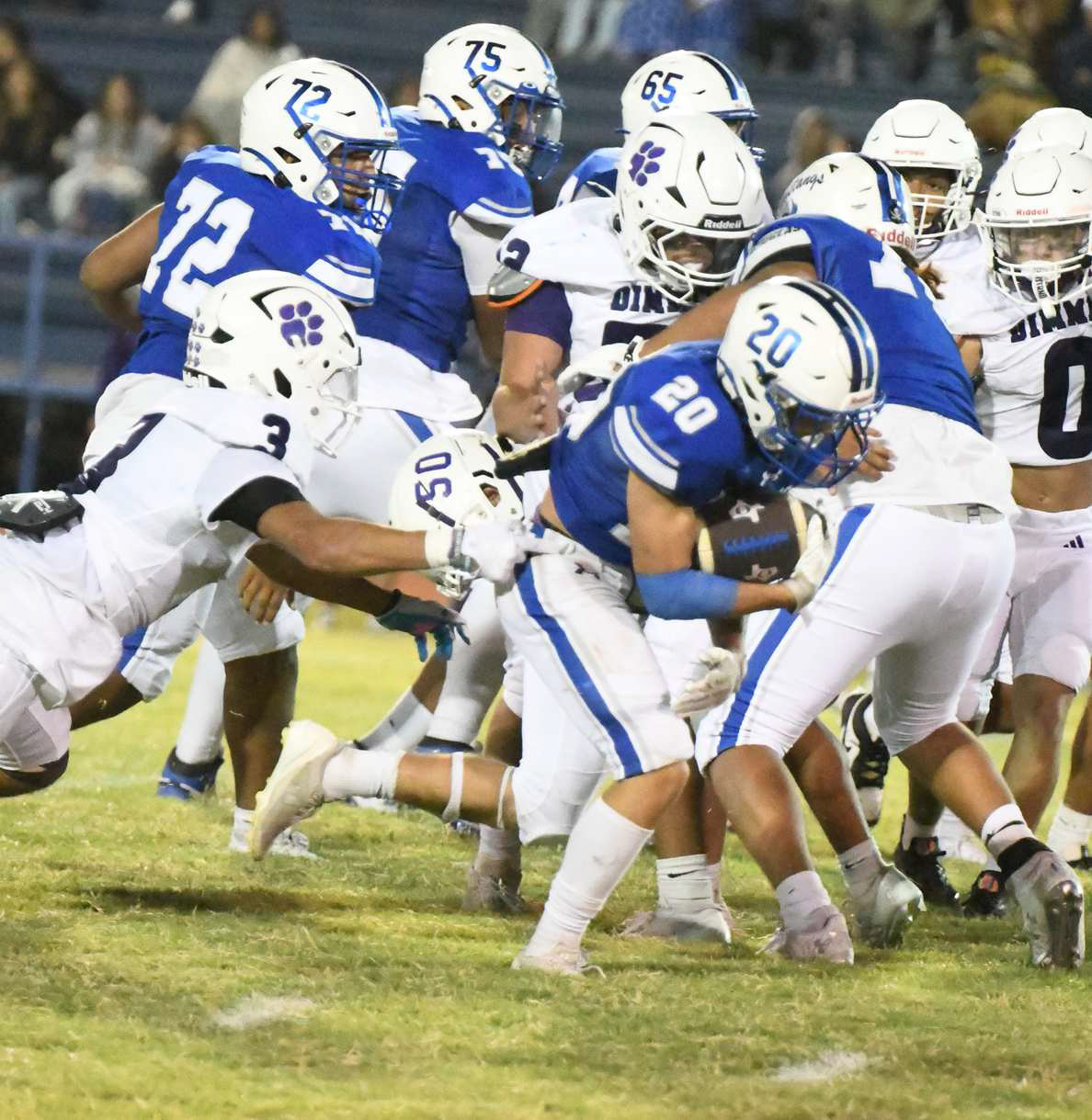 Olton running back, Callen Burns, shakes off a would-be tackler as he breaks through the line for a solid gain, during the second half of the Mustangs, 33-14, victory over the Dimmitt Bobcats on Friday at Mustangs Stadium. (Staff Photo by Derek Lopez)