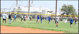 Olton Head Baseball Coach Matthew Ingle demonstrates how a relay throw should be received, during a drill to open the final day of his Basbeall Camp in June. (Staff Photo by Derek Lopez)