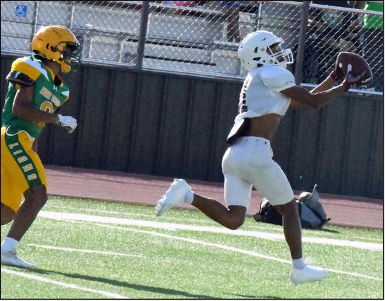 Littlefield’s Zane Champion beats the defense and catches a long touchdown pass from Nate Castaneda on the very first offensive play, during their scrimmage last Thursday with the Lions. (Staff Photo by Derek Lopez)
