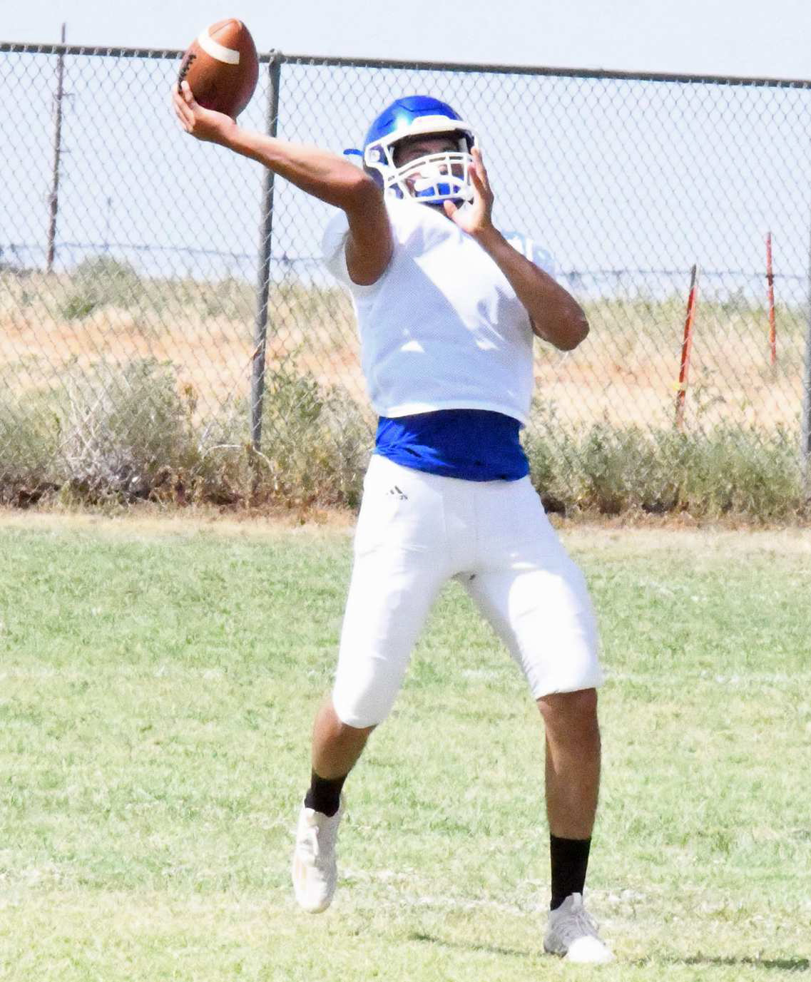 DELIVERING A STRIKE - Amherst sophomore quarterback, Joel Garcia, deliveres a strike to one of his receivers during offensive drills. (Staff Photo by Derek Lopez)