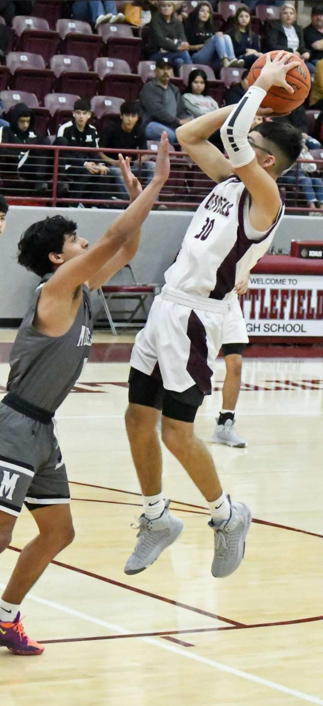 KNOCKING DOWN THE JUMPER – Littlefield senior, Jaron Cabello (30), knocks down a pull-up jumper from the left elbow, over the outstretched arm of the Muleshoe defender for the Wildcats’ first bucket of the game on Tuesday, during their senior night victory over the Mules, 73-30. (Staff Photo by Derek Lopez)