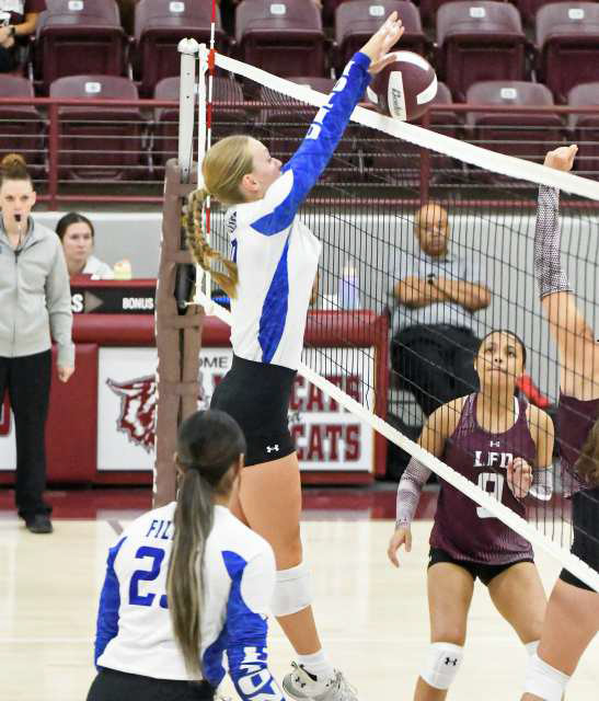 Olton’s Amie Beelitz deliveres a block against Littlefield, during their three-set match on Saturday at the Littlefield Tournament. (Staff Photo by Derek Lopez)