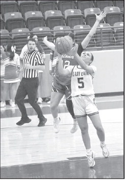 Littlefield’s Madison Williams (5), goes up for a tough lay-up through contact from Friona’s Aaliyah Padilla, during the first half of the Lady Cats’ win Tuesday night. (Staff Photo by Derek Lopez)