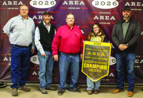 Reserve Grand Champion Heifer winner Rainey Hays poses with buyers from First United Bank, Lance Insurance, Lamb County Farm Bureau, Indian Ink Leasing, Caprock Dairy, Earth Fertilizer and Spraying and Lowe's.