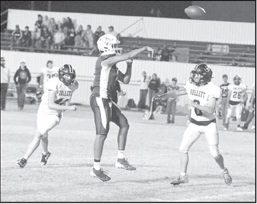 Amherst’s Joel Garcia connects with Oscar Conteras on an extra point pass, during the fourth quarter, of the Bulldog’s, 79-50, loss to Follett on Friday at Bulldog Stadium. (Staff Photo by Derek Lopez)