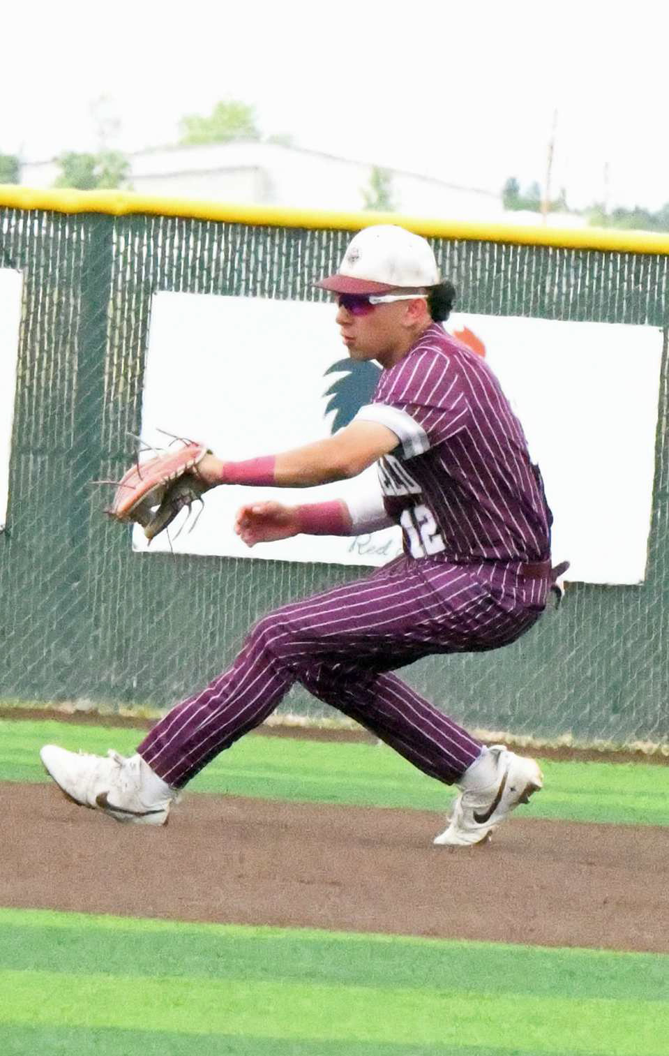 Littlefield shortstop, Ian Mendez, plays a ball to his right, as he throws it to first for the out in the bottom of the first inning of game one of the Wildcats’Area series against Denver City on Thursday. (Staff Photo by Derek Lopez)