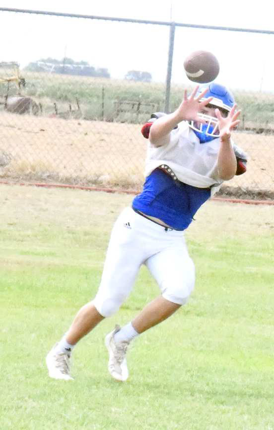 SEEING THE BALL IN -AnAmherst receiver sees a ball into his hands during practice on Tuesday. (Staff Photo by Derek Lopez)