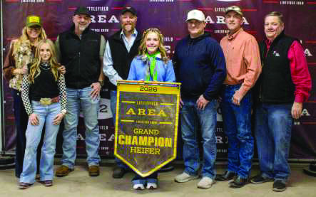 Grand Champion Heifer winner Sloane Beerwinkle poses with buyers from First United Bank, Lance Insurance, Western Equipment, BJM Sales and Service, Bill Weldon, Caviness Beef Packers, Olton Welding, C&amp;H Equipment, WDG Trucking, Lamb County Farm Bureau, Sawyer Construction, Texas Producers Co-Op, Lowe's, 2-Step Cattle, Cattlemans Feed Yard and Jeff and Jenn Edwards.