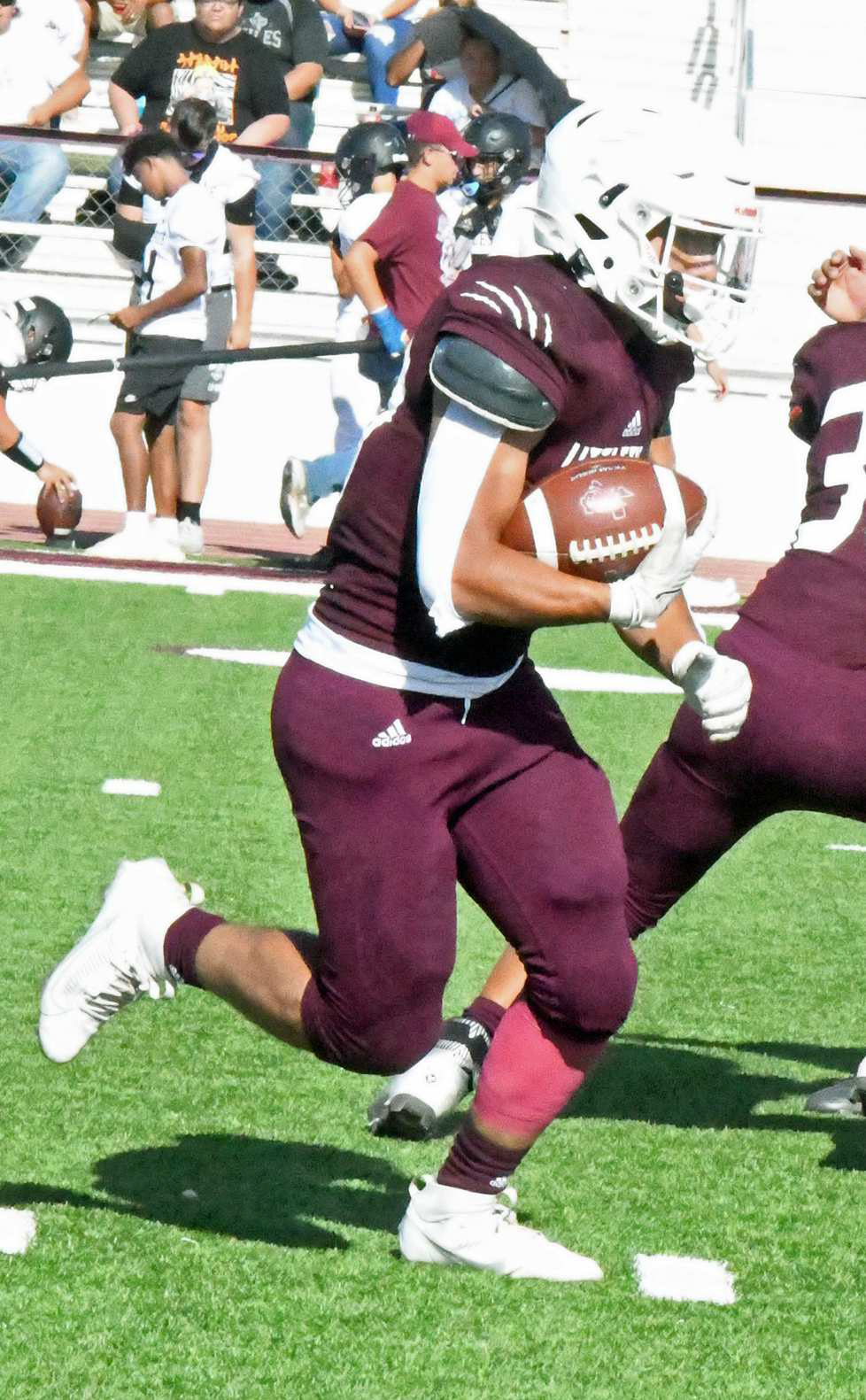 RUNNING HARD - Littlefield JV running back, Jaden Ojeda, takes a carry up the middle, for a solid gain, dragging defenders for a few extra yards, during the Wildcats’ season-opener against Muleshoe last Thursday. (Staff Photo by Derek Lopez)