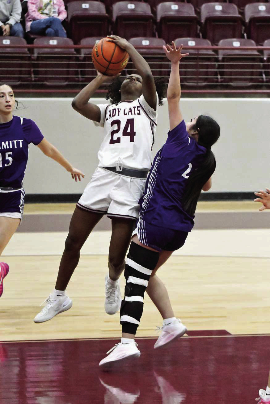 Littlefield sophomore, Amoni Jefferson ( 24), finished a lay-up through contact, during the first half of the Lady Cat’s district victory over Dimmitt at Wildcat Gym on Tuesday. (Staff Photo by Derek Lopez)