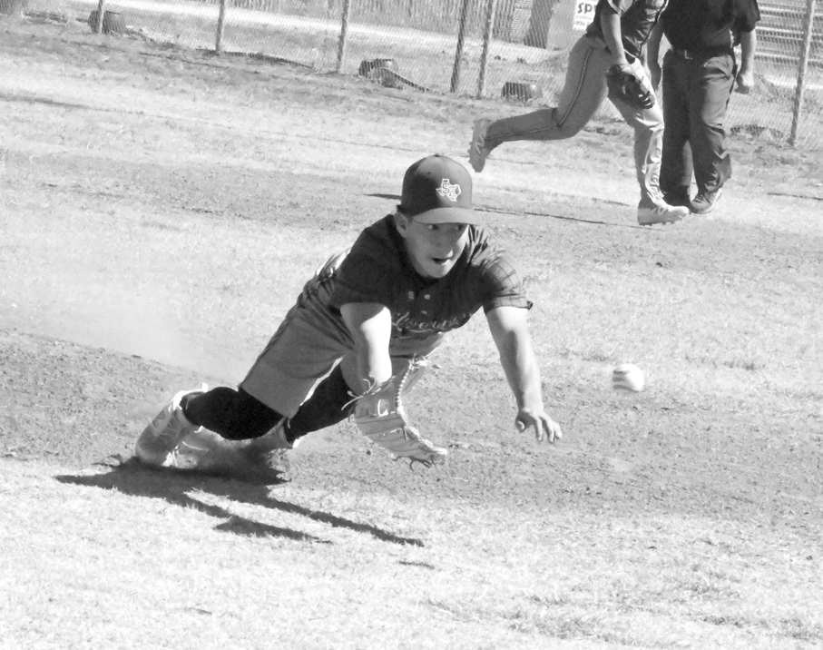 Springlake-Earth’s Froylan Agundiz, comes off the mound and makes a diving catch on a popped up bunt for an out, during the top of the first inning of the Wolverines’ loss to the WTX Tornadoes on Friday at the Lamb County Classic. (Staff Photo by Derek Lopez)