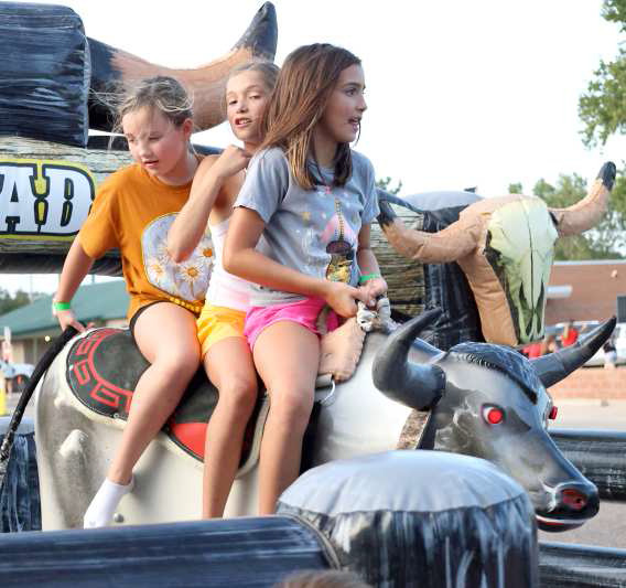 Some kids give the Mechanical Bull a try at the 44th annual Sandhills Celebration that took place last weekend. (Photo by Wesley Quigley)