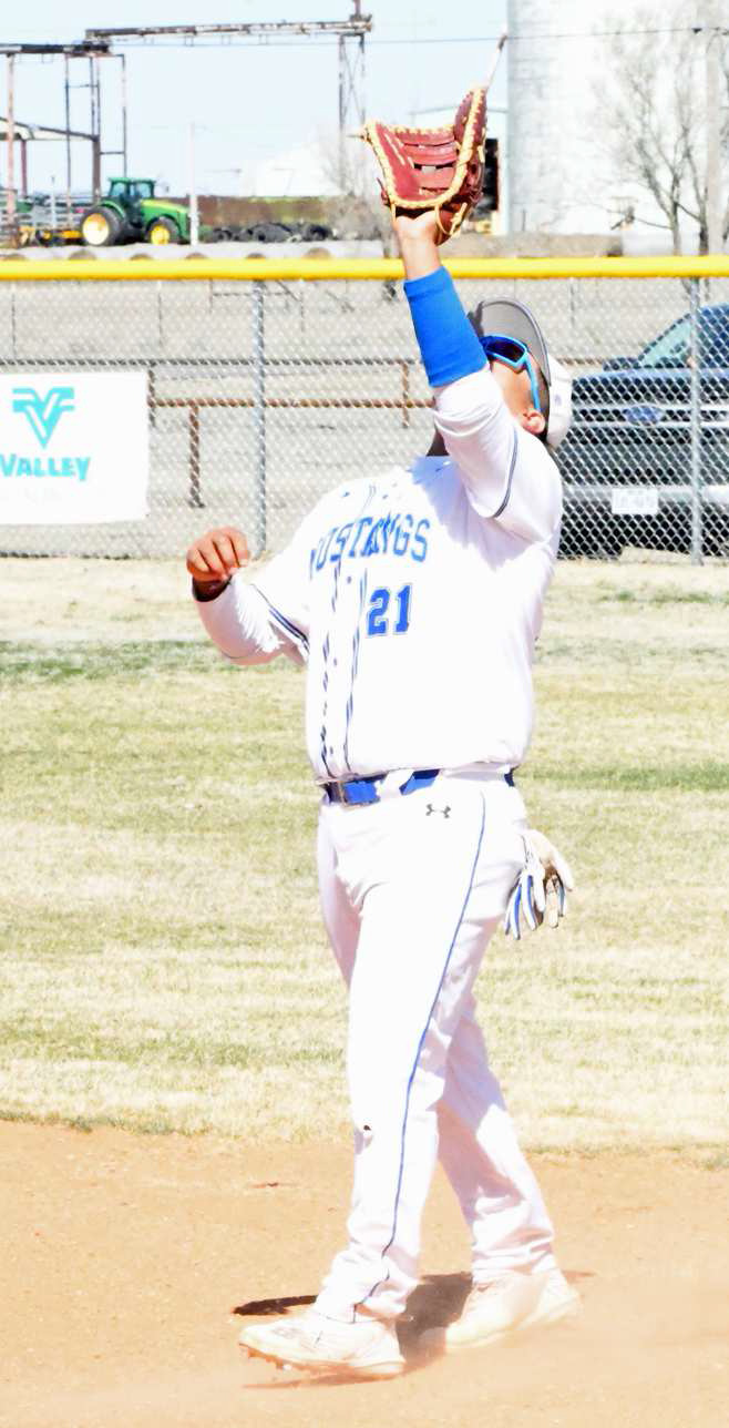 Olton junior, Adolfo Garcia, catches a pop up at first base for an out against the Hale Center Owls on Monday, during their district-opener in Olton. (Staff Photo by Derek Lopez)