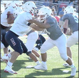 HOLDING YOUR BLOCK - Littlefield sophomore tackle, Marcquis Rosemond, locks on to a defender, getting his block, giving quarterback, Chip Green, time in the pocket, during the live quarter portion of their scrimmage on Friday against the Lions at Trinity Christian. (Staff Photo by Derek Lopez)
