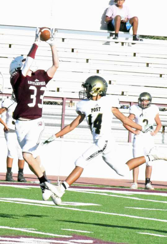 CATCH AND RUN – Littlefield’s Brayden Redman (33) catches a pass from quarterback Nate Castaneda over the Post defense for a huge gain, during the Wildcats’, 36-18, victory over Post at Wildcat Stadium on Thursday. (Staff Photo by Derek Lopez)