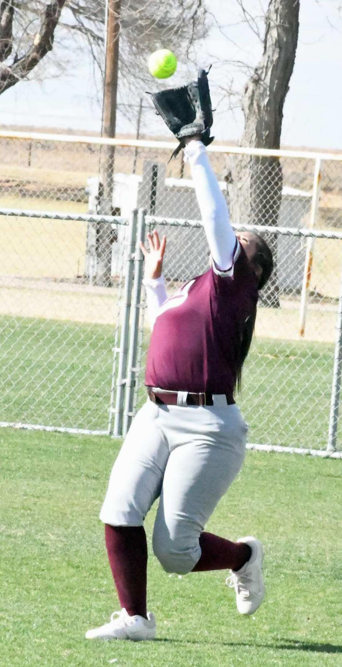OUT IN THE AIR – Littlefield right fielder, Alex Hernandez catches a fly ball in right field for an out, during the Lady Cats’, 8-4, victory over the Denver City Fillies on the road on Wednesday. (Staff Photo by Derek Lopez)