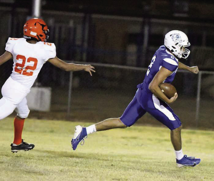 Amherst’s Joel Garcia (2), carves through the Lazbuddie defense for a touchdown, during the first-half of the Bulldog’s final district game of the season last Thursday. (Staff Photo by Derek Lopez)