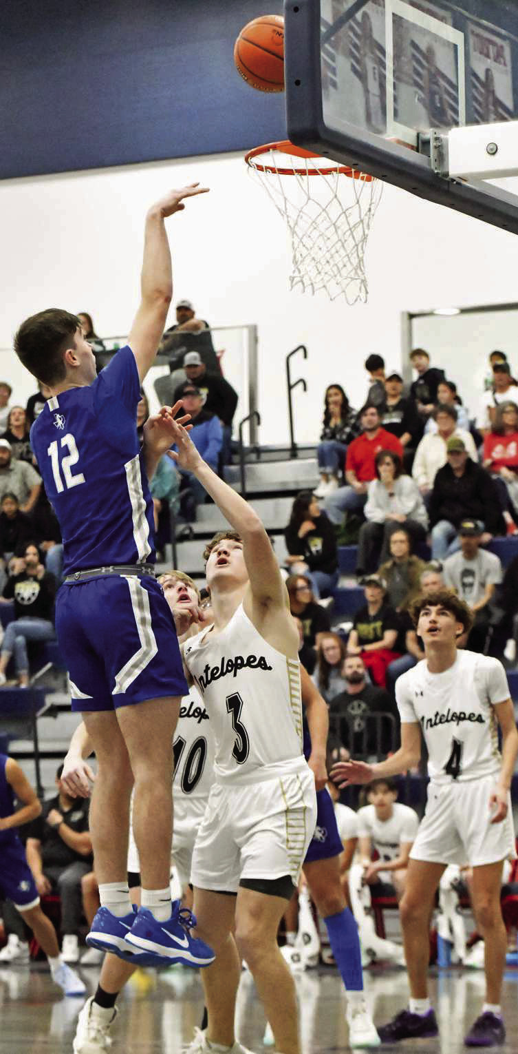 Olton’s Brady Azam (12) drops in a lay-up for twoof- his team-high 16 points, during the Mustang’s, 70-31, victory over Post in the Class 2A-DI Bidistrict championship game at Liberty HS on Tuesday. (Staff Photo by Derek Lopez)