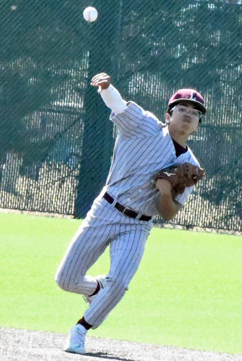 OUT AT FIRST - Littlefield second baseman, Isaiah Rodriguez, fields up a ball at second base and throws it to first for an out, during the Wildcats, 8-7, loss to River Road on Saturday in Littlefield. (Staff Photo by Derek Lopez)