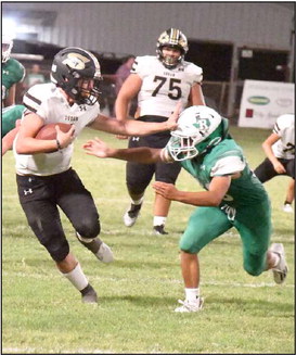 SHAKING OFF THE DEFENSE -Sudan quarterback, Trent Wilson, stiff arms a Ropes defender on his way to a solid gain in the second half of the Hornets’, 24-21, victory over the Eagles on Friday. (Staff Photo by Derek Lopez)