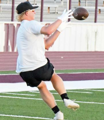 Bradyn Redman catches an out route, during route running drills at Littlefield’s Park Practice on Monday at Wildcat Stadium. (Staff Photo by Derek Lopez)