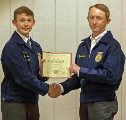 FFA Vice President Ty Carr presents Ryan Muller with a Greenhand FFA Degree at the annual FFA banquet on May 12, 2025. (Staff Photo by Madison Vidales)