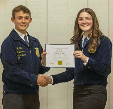 FFA Secretary Devyn Crouch presents FFA Vice President Ty Carr with a Chapter FFA Degree at the annual FFA banquet on May 12, 2025. (Staff Photo by Madison Vidales)