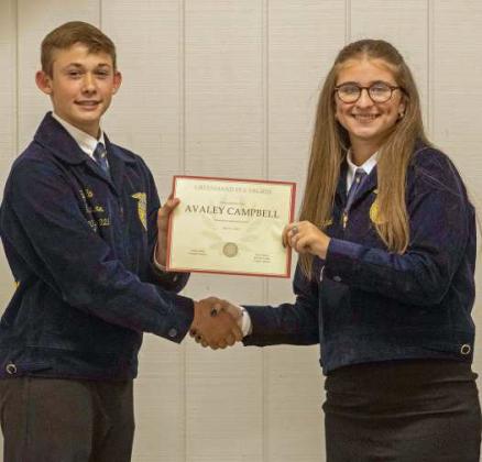FFA Vice President Ty Carr presents Avaley Campbell with a Greenhand FFA Degree at the annual FFA banquet on May 12, 2025. (Staff Photo by Madison Vidales)