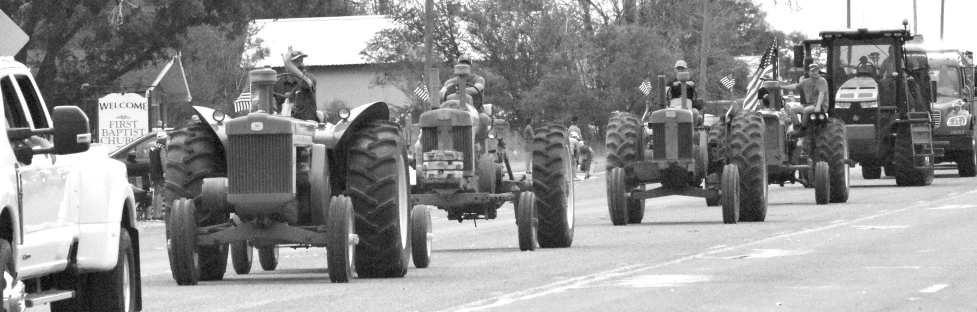 Families drive their tractors in the Springlake Fourth of July parade.