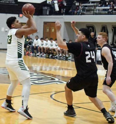 SHOOTING THE JUMPER - Springlake-Earth junior forward Keshan Holmes (33), pulls up for a jumper from the right elbow over Texline’s Noel Lozano (24), during the first half of the Wolverines’ loss to the Tornadoes in the lARegional Quarterfinal game at Randall High School. (Staff Photo by Derek Lopez)