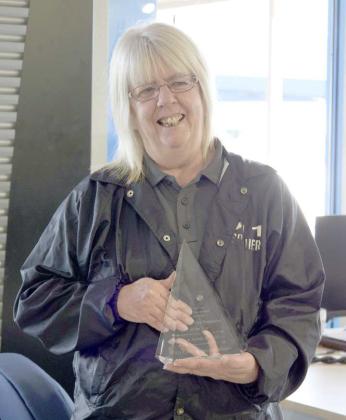 Ann Robison, Lamb County’s 911 Communications Operator, receives the First Responder of the Year award by Premiere Chevrolet GMC of Littlefield on Oct. 16. (Staff Photo by Rhode Duenas)