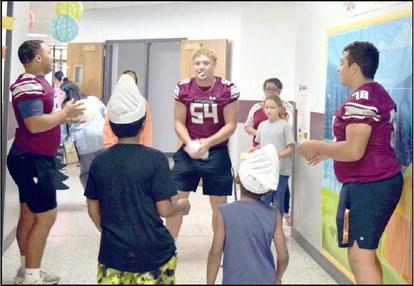 MAKING ICE CREAM in a plastic bag was a very popular activity at the Littlefield Primary Family Reading Night Thursday, September 28. Left to right- Marquis Rosemund, Brandon Bowman, and Sean Ybarra join Jabrien Harris and Darrius Harris in a team effort to make some ice cream during the Family Reading Night at Littlefield Primary. (Photo by Ann Reagan)