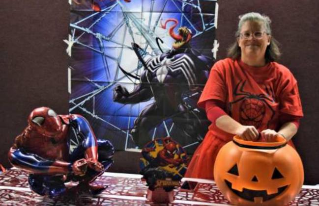 Nikki Turney hands out candy at her Spiderman booth during First Baptist Church of Littlefield’s Hallelujah Night on Wednesday. (Photo by Ann Reagan)