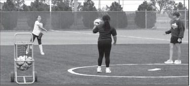 Suzanne Perry, assistant coach for Littlefield softball, helps guide players through drills during the youth camp on June 18.