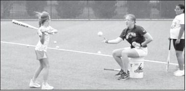 Ally Oyanguren, head softball coach at Littlefield, instructs campers during a drill at the Littlefield Youth Softball Camp on June 18.