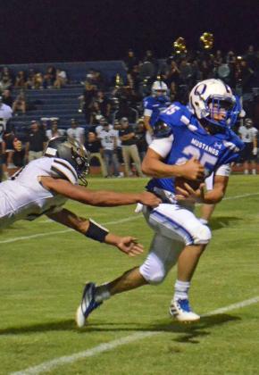 STRONG RUNNING - Olton running back, Baldo Garcia (25), breaks a would-be Sudan tackle for a nice chunk of yards, during the second half of the Mustang’s, 49-0, shutout of the Hornets on Friday in their home-opener. (Staff Photo by Samantha Pontius)