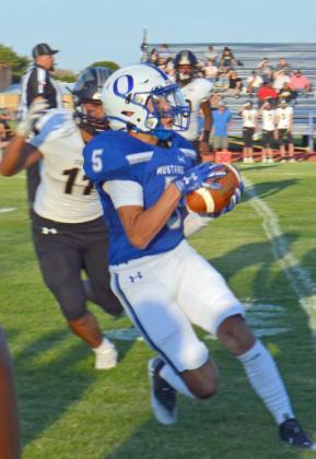 DOWN THE SIDELINE - Olton senior wide receiver, Jake Soliz (5), catches a pass on the near sideline and breaks free for a 34-yard touchdown to put the Mustangs up, 14-0, on Friday in a, 49-0, shutout over Sudan. (Staff Photo by Samantha Pontius)