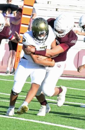 SACKING THE QUARTERBACK – Littlefield defensive lineman, Sir Pratt, breaks through the line and wraps up the quarterback for a sack, during their, 36-18, victory over Post at Wildcat Stadium on Thursday. (Staff Photo by Derek Lopez)