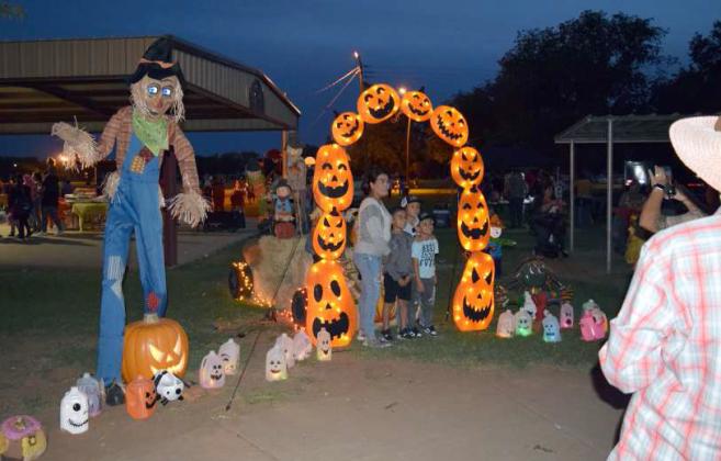 Pumpkin Trail visitors pose for a photo at a photo booth, during the 2023 Pumpkin Trail at Crescent Park. (Photo by Ann Reagan)